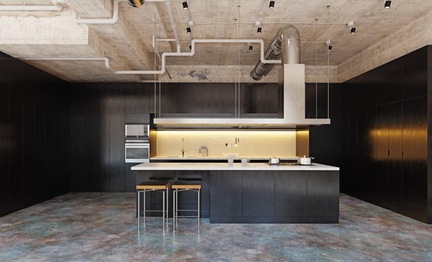 Kitchen with backlit backsplash, white quartz countertops and black cabinets