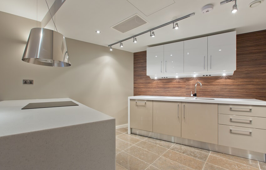 White cabinets, glossy wood backsplash and granite island 