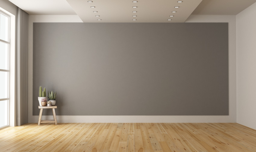 Empty room with wood flooring, gray wall, recessed lights, and window