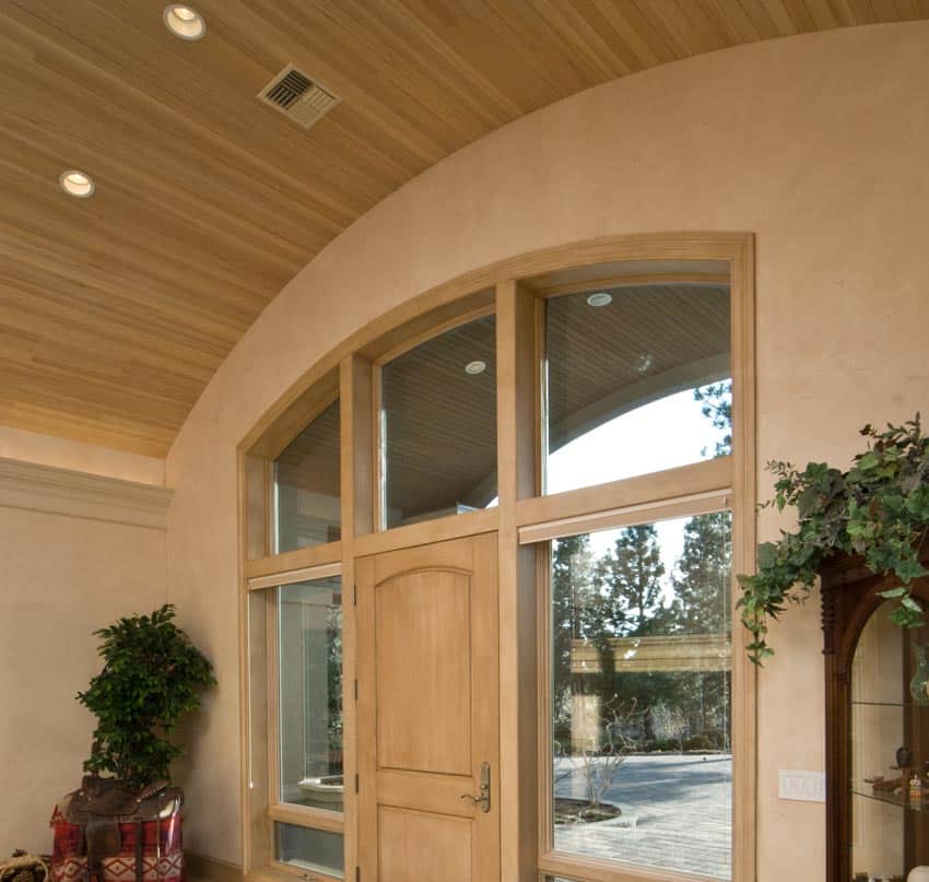 Foyer entrance area of a house with curved wood ceiling