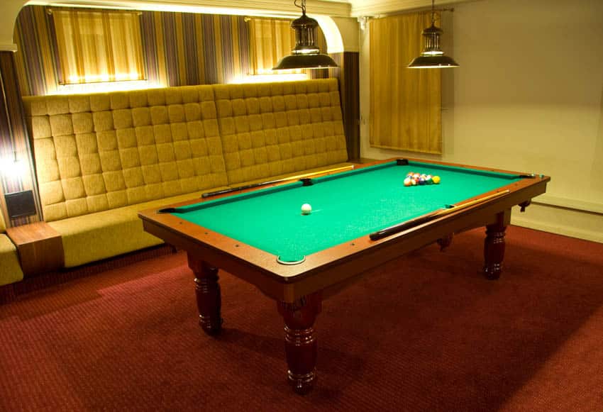 Game room with white couch, pendant lights, red carpet, and pool table