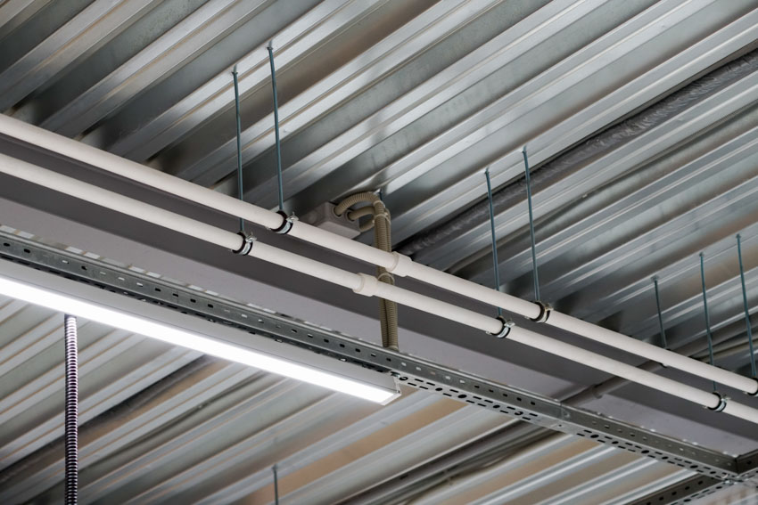 High bay fluorescent light installed on metal ceiling