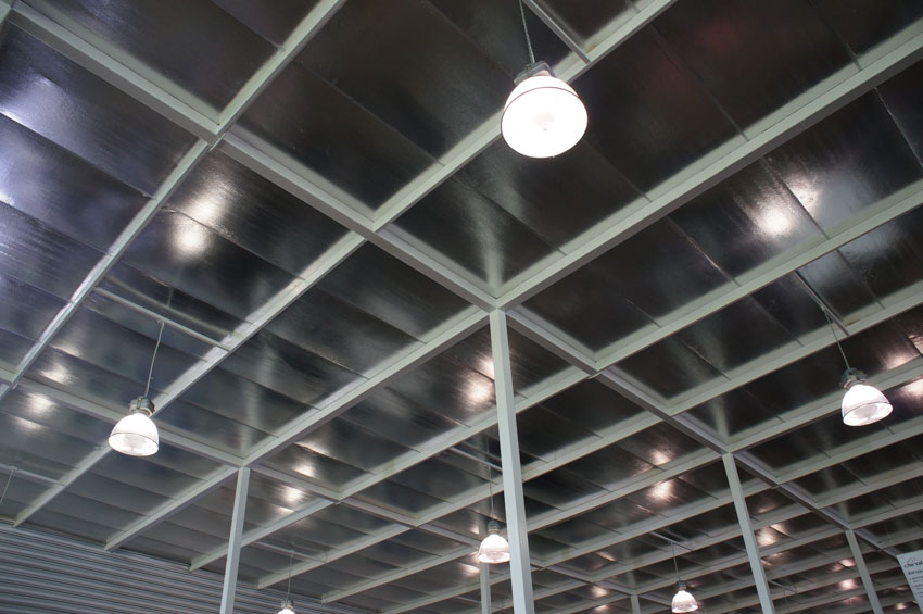 High bay lighting fixtures on metal ceiling with support
