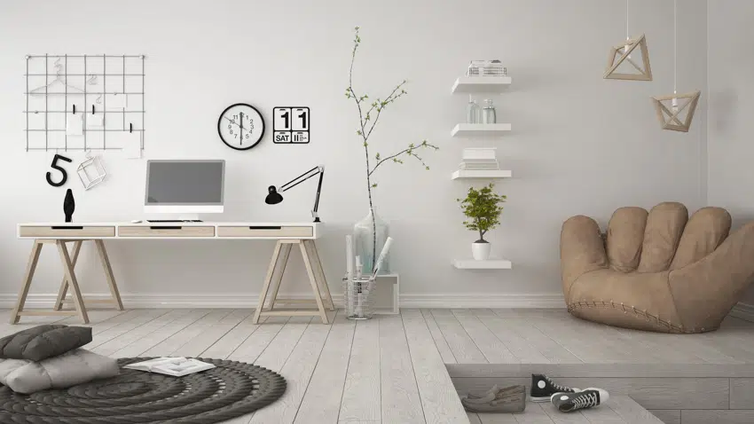 Home office with different wall decor ideas, computer, table, and wood floor