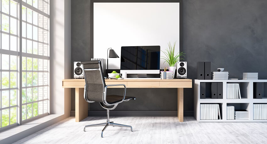 Home office with large windows white filing cabinet with documents black and silver office chair and computer lamp and speakers on wood desk
