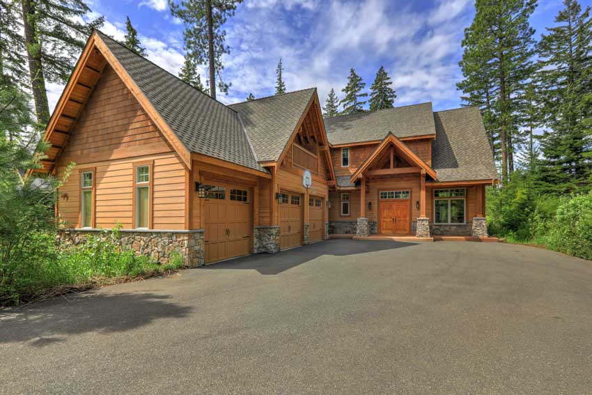 House with log siding with trees in the background