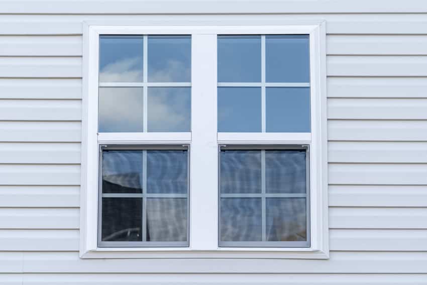 House exterior with white siding and double hung windows