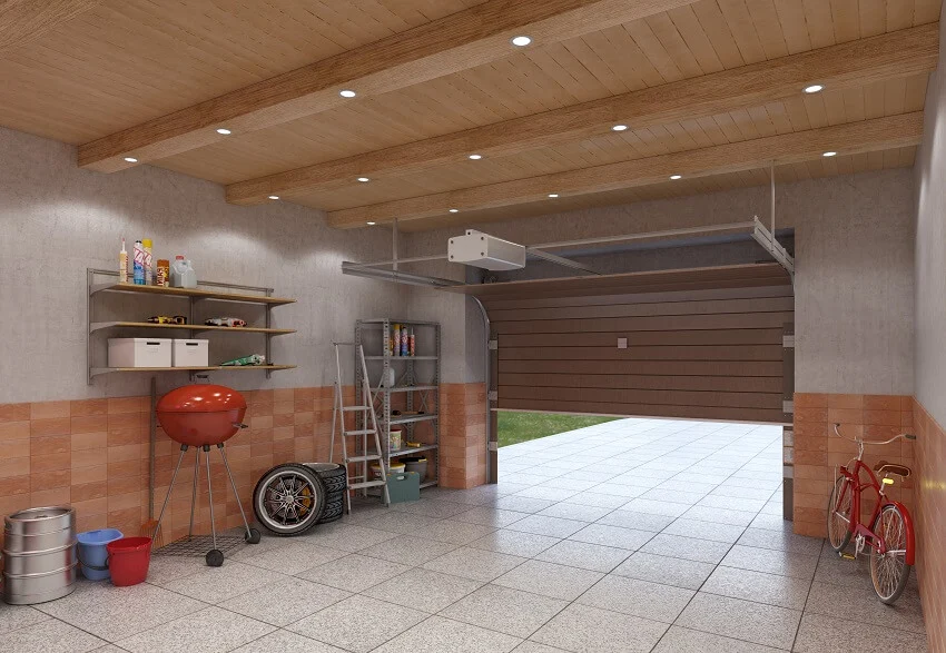 Insulated garage interior with tile floors wood beams with lighting fixtures wood panel ceiling open shelves and a brown lifting door