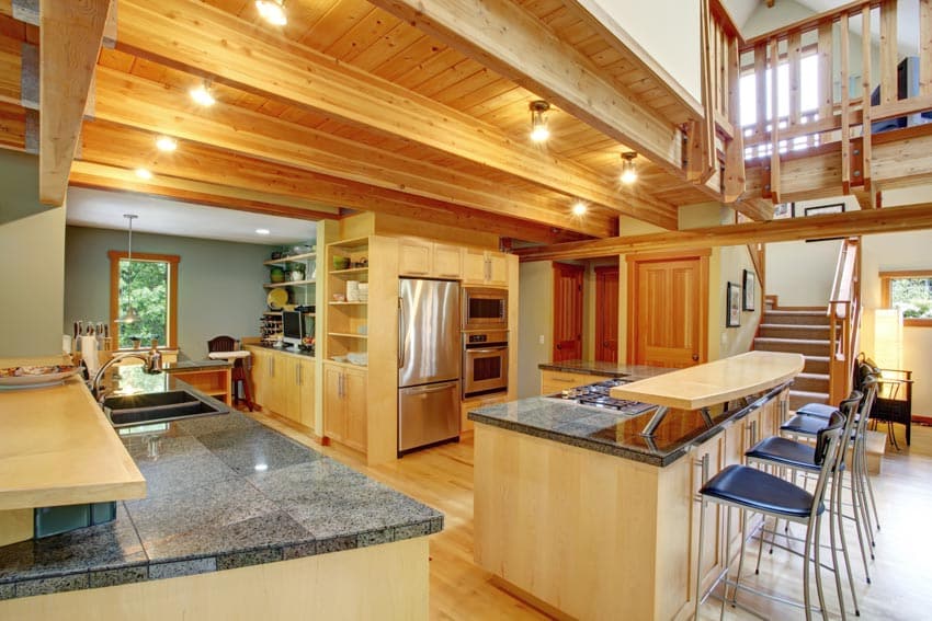 Kitchen and dining room combined with types of wood ceiling, lighting fixtures, center island, high chairs, and countertop