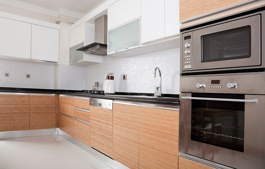 Kitchen with countertop, frosted glass cabinets and built in oven