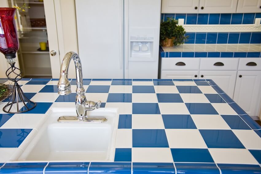 Kitchen island with blue and white colorful tile surface