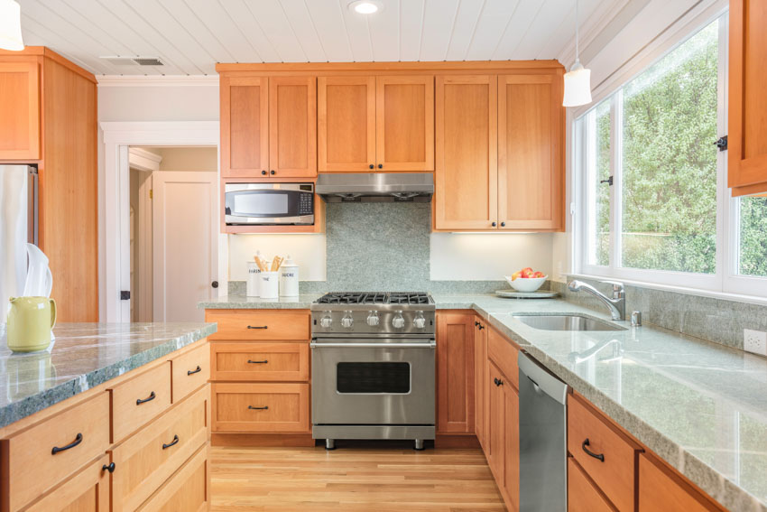 Kitchen with oak cupboards, and black handles