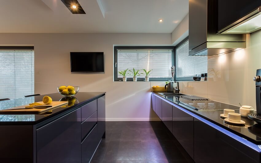 Kitchen with black tile floor, white walls, and black counters