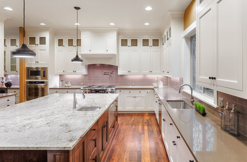 Kitchen with shaker cabinet, knobs two tone cabinetry and honed surfaces