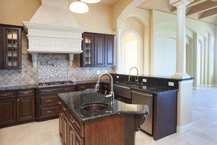 Kitchen with center island, cabinets, gemstone countertops, and drawers