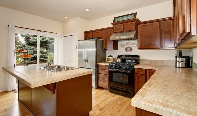 Are Tile Countertops Right For Your Home Weighing The Pros And Cons   Kitchen With Ceramic Tile Countertops Wood Cabinets And Floors Windows With White Curtain And Island With Sink Is 768x455 