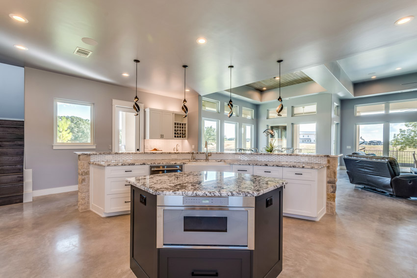 Kitchen with drawer dishwasher, center island, recessed lighting fixtures, and pendant lights