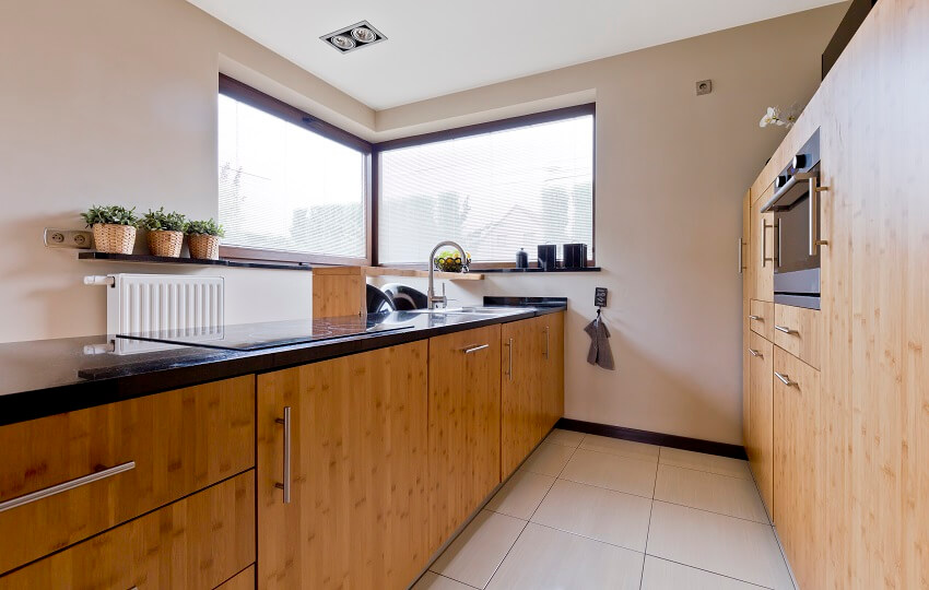 Kitchen with glass corner windows and countertops with ceramic cooktop