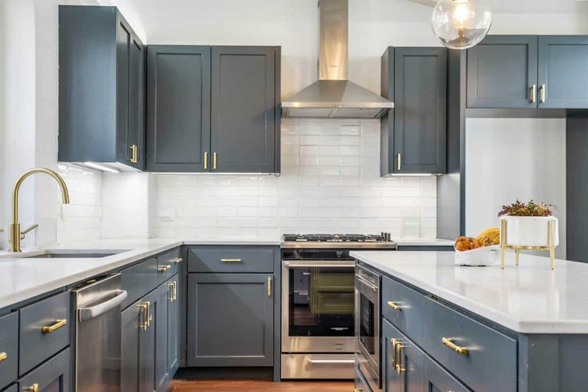 Kitchen with gray cabinets and straight set tile for the backsplash