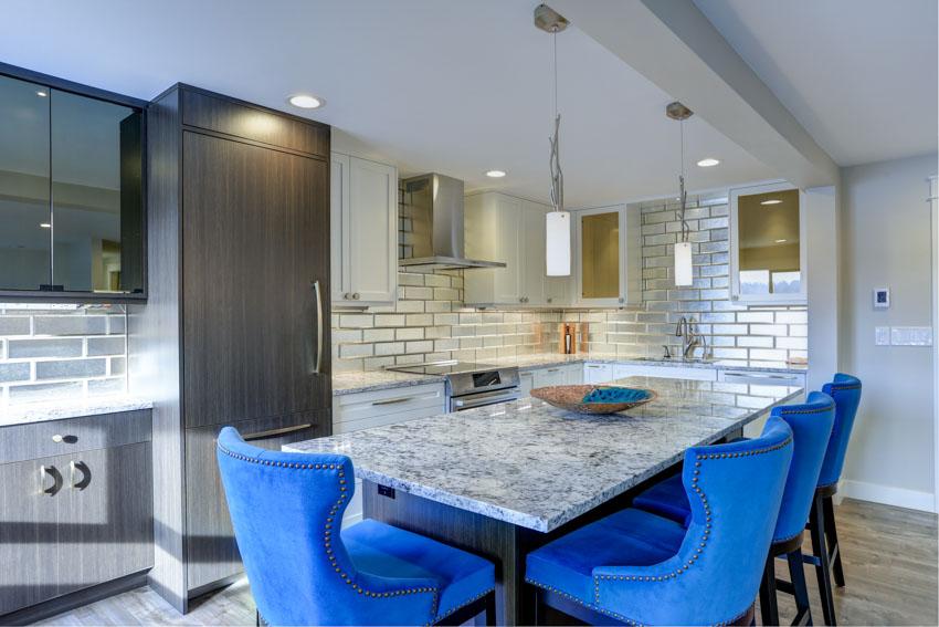 Kitchen with honed quartzite counter, pendant light, and metal tile backsplash