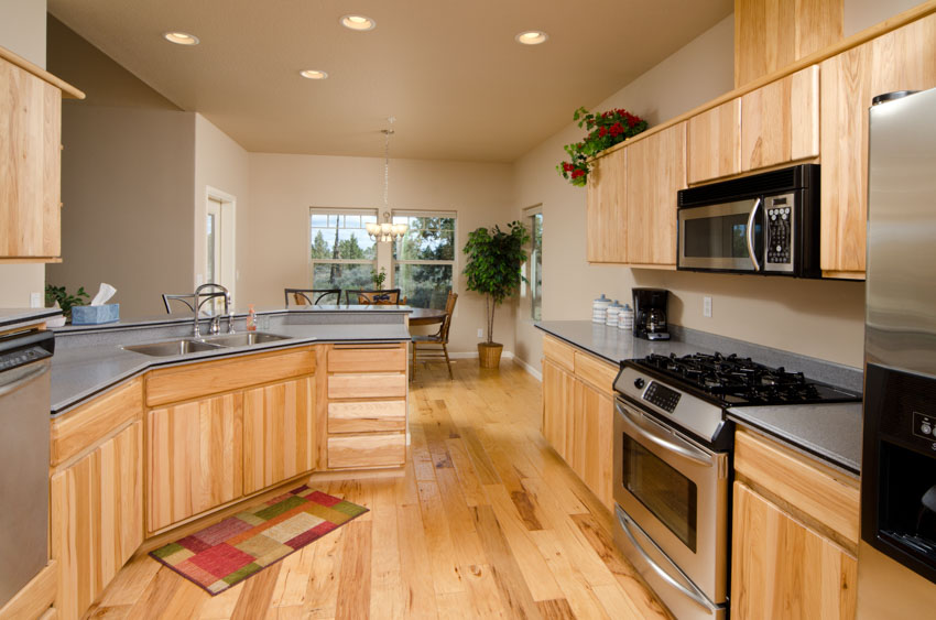 Kitchen with light oak and grey countertops