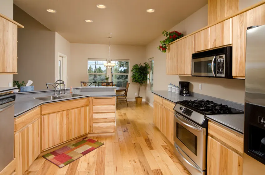 Kitchen with light oak cabinets, wood flooring, and countertops