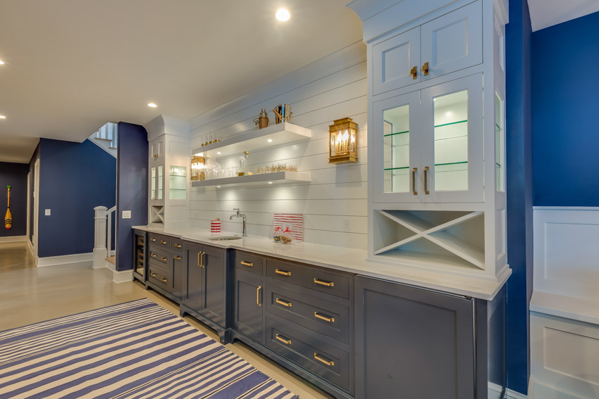 Kitchen with shiplap backsplash, gray cabinets, rug, wood floor and countertop