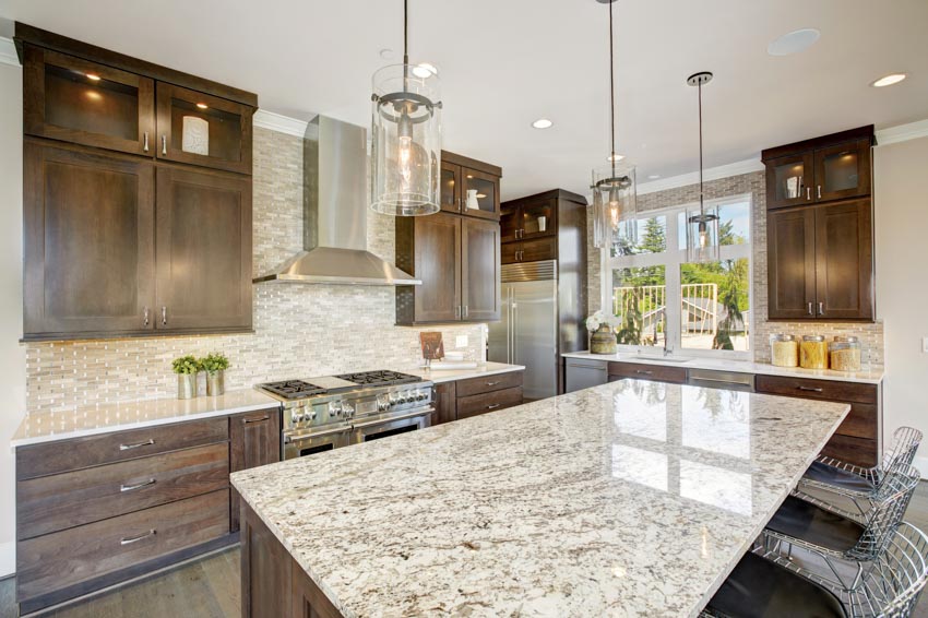 Kitchen with glass backsplash, and granite center island
