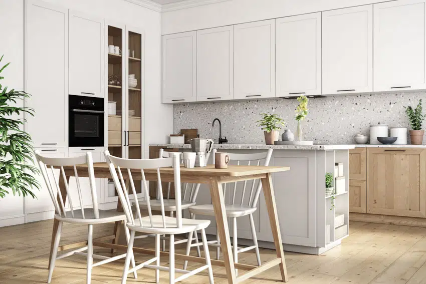 Kitchen with white slatback chair and cabinets with glass front