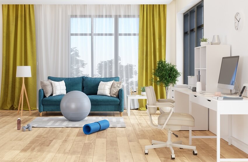 Living room and home office interior with wood floors white desk computer office chair blue sofa sports equipment and yellow curtains
