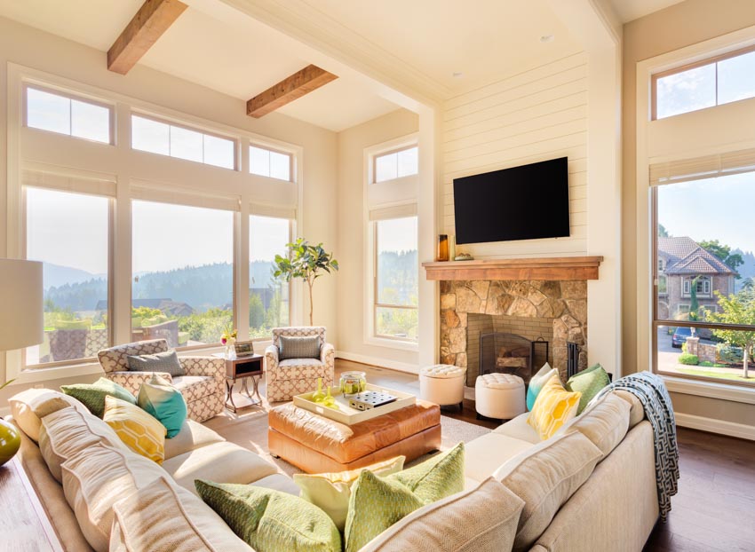 Modern transom windows, sofa, fireplace, and wood beams