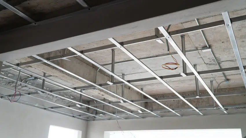 Metal grid installed to a ceiling with provisions for electrical wiring and lighting fixtures