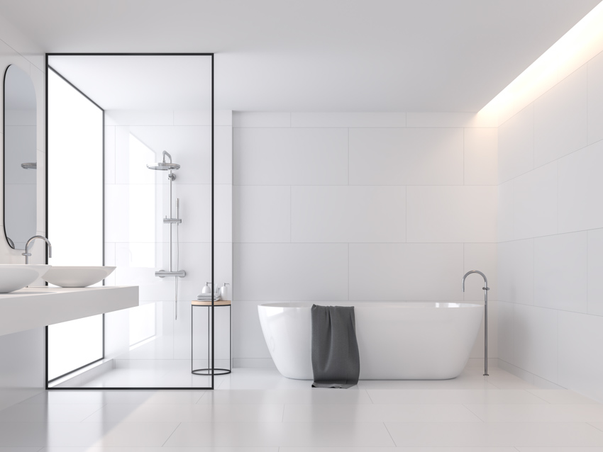 Minimalist bathroom with tub and large subway type tiles