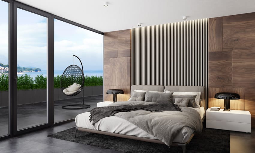 Room with wide windoews, swing chair, floating bed with grey pillows