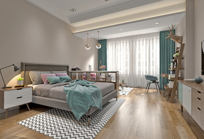 Modern guest bedroom with wood floors cubby hole storage console table workspace coffee table couch pendant lights floor to ceiling curtains and a large comfy bed