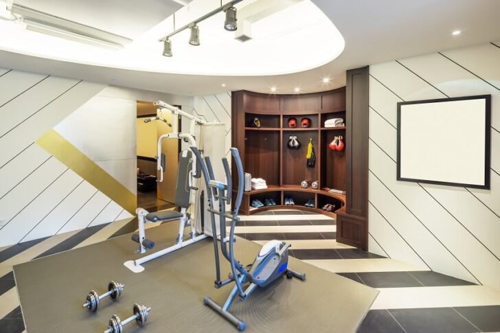 Home Gym Lighting Ideas 6 Best Options   Modern Home Gym With Tile Floor Panel Wall Dark Wood Cubby Storage With Bench Lighting Fixtures And Gym Equipments On Grey Mat Is 728x485 