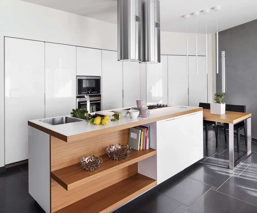 Kitchen with black floors, two cylinder range hood glossy type cabinets and island with shelving