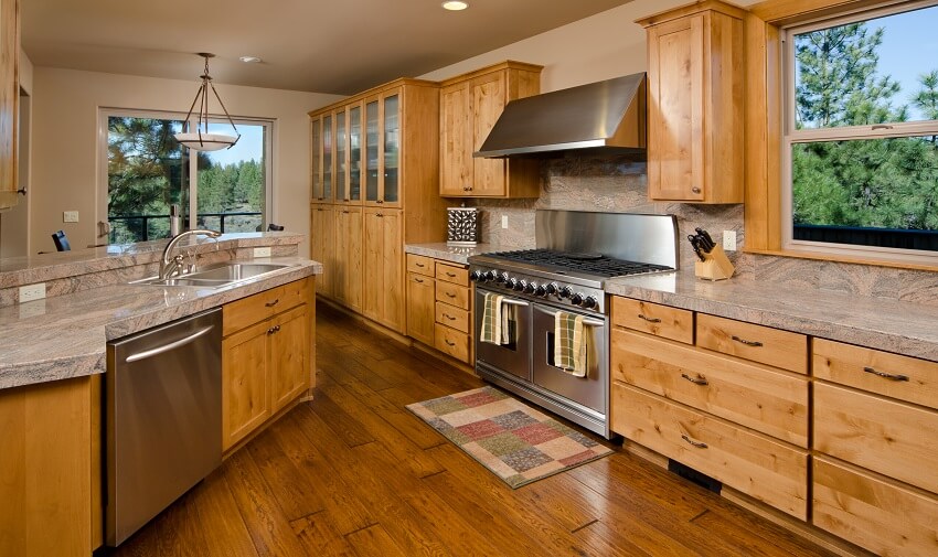 Kitchen with flat and shaker door cabinets and laminate countertops