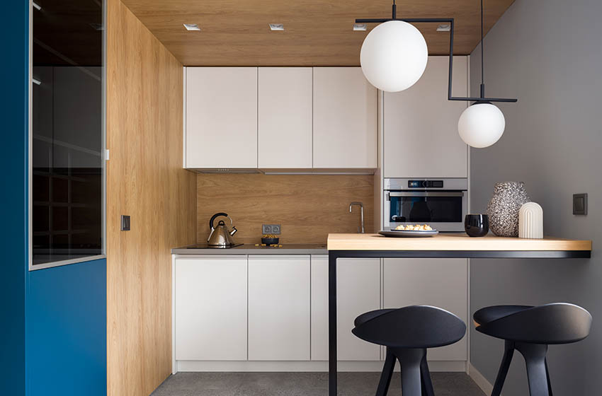 Modern kitchenette with peninsula wood accent walls