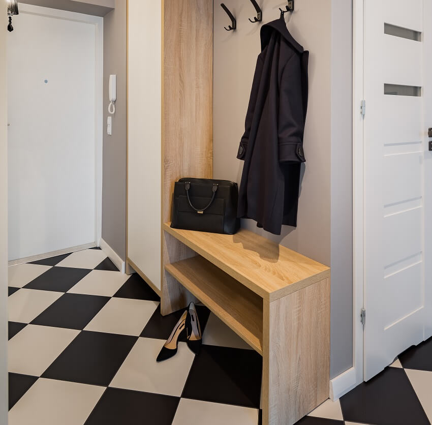 Modern mudroom with chess floor tiles wardrobe cabinet wood bench and coat hooks