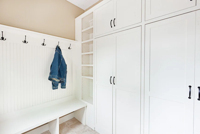 Mudroom white cabinets bench wall hooks
