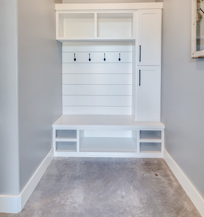White painted cubbies and shelves and concrete floor