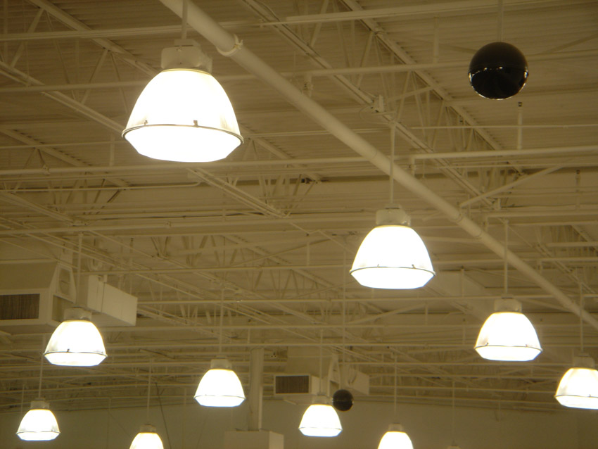 Multiple high bay lights on metal ceiling