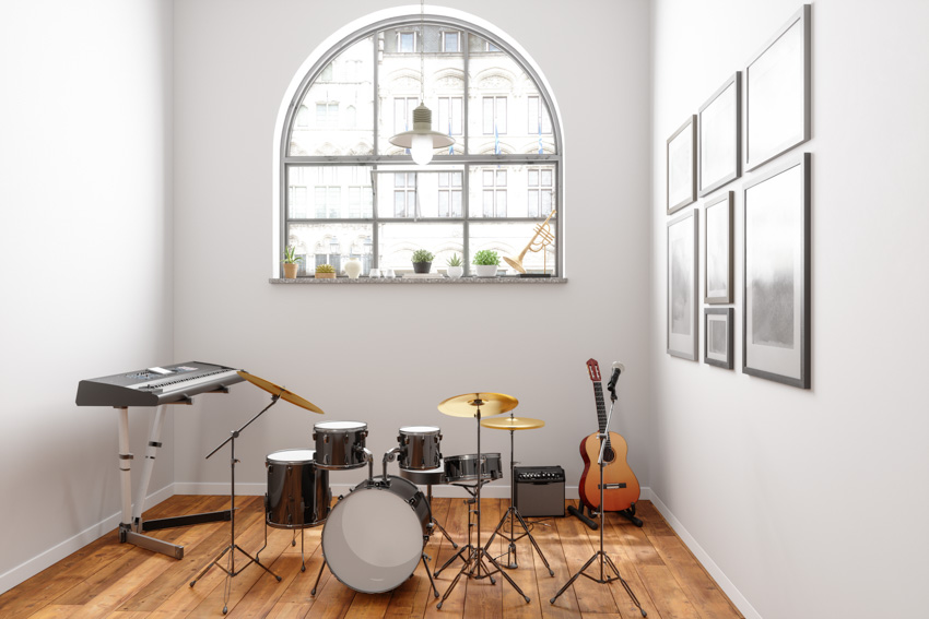 Music room window wood floor drum set piano guitar white wall