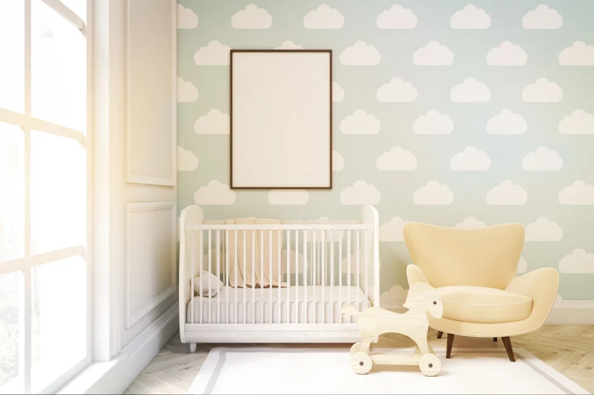Nursery room with wallpaper, crib, chair, rug, and window