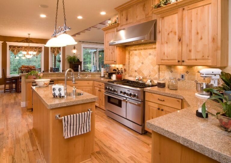 Open Kitchen With Knotted Pine Cabinets Tile Countertops Oak Floors Pendant Lights And View Of The Dining Area With Large Windows Is 768x544 