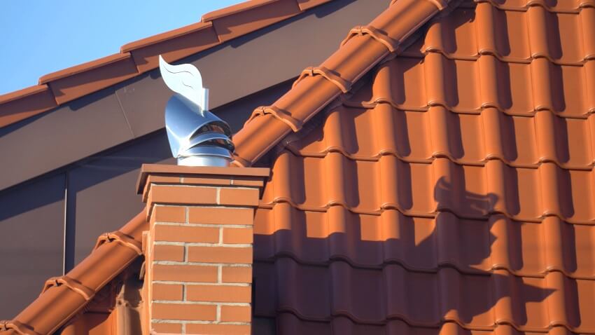 Orange roof and chimney with wind-directional chimney cap