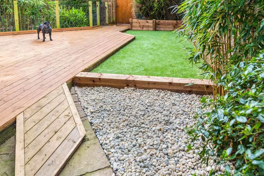 Outdoor space with wood patio and artificial turf