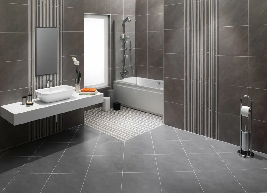 Rectified tile surfaces for bathroom with a sink, countertop, window, tub, and tub shower combo