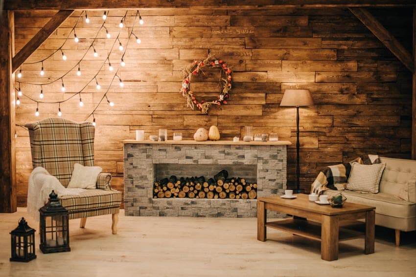 Room with wood accent wall, fireplace, chairs, and decor items